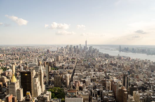 pexels-photo-529621-529621 A breathtaking aerial view of New York City showcasing the iconic skyline over the river under a clear sky.