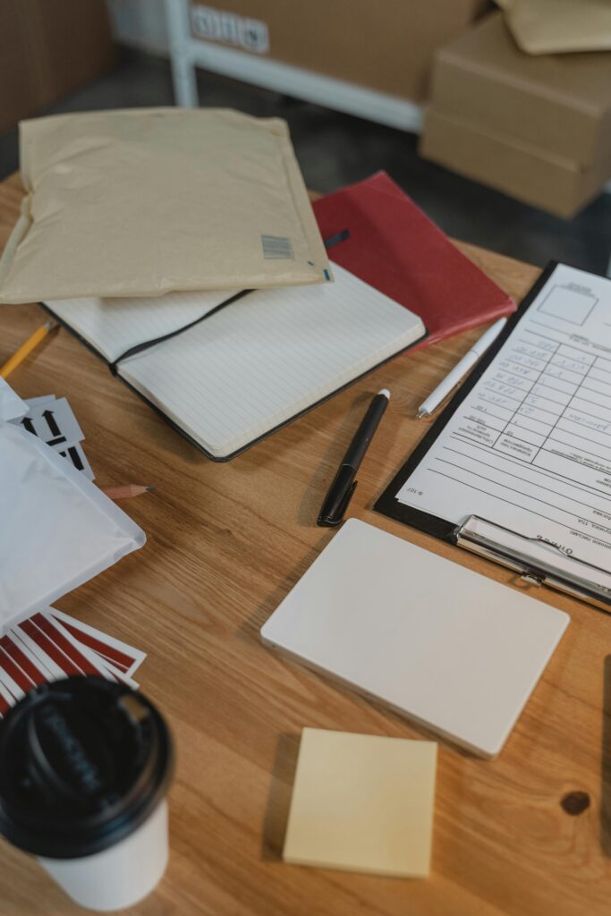 pexels-photo-6169018-6169018 A well-organized desk with delivery packages, clipboard and coffee.